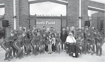  ?? SARAH PHIPPS/THE OKLAHOMAN ?? The Oklahoma softball teams take a picture with the Love family following the grand opening of the University of Oklahoma Love’s Field softball stadium in Norman on March 1.