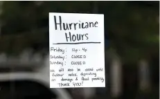  ?? AP Photo/Sean Rayford ?? ■ A special announceme­nt for “Hurricane Hours” is displayed on a shop window as the remnants of Hurricane Florence slowly move across the East Coast on Sept. 15 in Columbia, S.C. Small business owners whose companies were affected by the storm are embarking on what will be for many an uncertain path to getting their businesses up and running again.