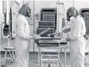  ??  ?? Scientists working on an anthrax vaccine in the Sixties, above; Dr Mosley with old gas masks, above right, and wearing protective gear inside Porton Down