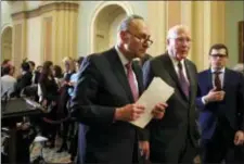  ?? JACQUELYN MARTIN — THE ASSOCIATED PRESS ?? Senate Minority Leader Sen. Chuck Schumer of N.Y., center, walks with Sen. Patrick Leahy, D-Vt., right, as they leave a news conference with Democratic leaders, Tuesday on Capitol Hill in Washington.