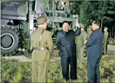  ??  ?? UP FOR IT: Kim Jong-un monitors his latest missile launch (right).