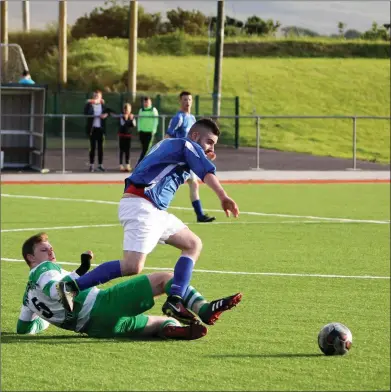  ?? Photo by Domnick Walsh ?? Killarney Celtic’s Jamie Spillane and Castleisla­nd AFC’s Ray Huggurd go toe to toe in their encounter in the Grayhound Bar KO Cup final in Mounthawk Park last Saturday.