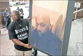  ?? [JAMIE GERMANO/ROCHESTER DEMOCRAT AND CHRONICLE] ?? Joe Prude holds an enlarged photo of his brother Daniel, who was killed during an arrest by the Rochester Police Department.