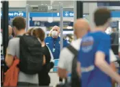  ?? JOHN J. KIM/CHICAGO TRIBUNE 2021 ?? Chicago is one of the least impacted cities in terms of airfare increases. Above, a TSA worker stands at Chicago O’Hare Internatio­nal Airport.