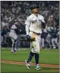  ?? LINDSEY WASSON – N.Y. TIMES ?? Julio Rodriguez of the Mariners jogs away after flying out in the 18th to end Saturday's ALDS game.