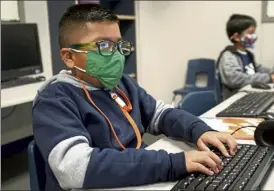  ?? Ap file ?? students wearing face masks work on computers at Tibbals Elementary school in Murphy, Texas.