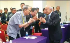  ?? HENG CHIVOAN ?? Funcinpec party President Prince Norodom Ranariddh (right) attends a party meeting on Saturday in Phnom Penh.