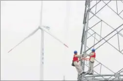  ?? SONG WEIXING / FOR CHINA DAILY ?? Technician­s check wind power facilities in Tianchang, Anhui province.