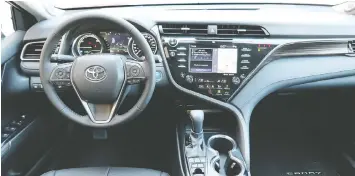  ??  ?? The Toyota Camry Hybrid’s controls are convenient­ly packaged and simple to use.