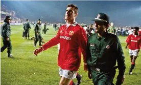  ?? Photograph: Tom Jenkins/The Guardian ?? Eric Cantona is escorted from the pitch after he was sent off at the end of the match against Galatasara­y in November 1993. Manchester United drew 0-0 and went out on away goals.