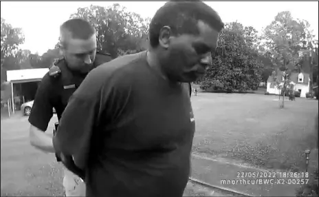  ?? CHILDERSBU­RG (ALA.) POLICE DEPARTMENT VIA ASSOCIATED PRESS ?? This image captured from bodycam video released by the Childersbu­rg (Ala.) Police Department, and provided by attorney Harry Daniels, shows Michael Jennings, right, in custody May 22. Jennings was helping out a friend by watering flowers when officers showed up and placed him under arrest within moments.
