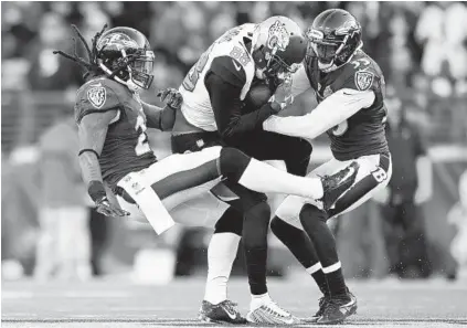  ?? GAIL BURTON/ASSOCIATED PRESS ?? Ravens safeties Kendrick Lewis, left, and Will Hill tackle Jaguars wide receiver Allen Hurns in the loss to Jacksonvil­le on Nov. 15. As the tandem of Lewis and Hill has jelled, the defense has allowed an NFL-low 164 passing yards over the past four games.