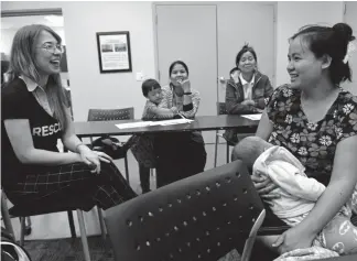  ?? Helen H. Richardson, The Denver Post ?? Internatio­nal Rescue Committee skills trainer Pola Laskus, left, chats with Burmese refugee Mu Meh during a job skills class at a library in Aurora on Oct. 1. Immigrants and refugees make up about 10% of Colorado’s population of nearly 5.7 million people.