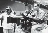  ?? NEAL ULEVICH THE ASSOCIATED PRESS ?? May 2, 1987: Bertolucci, right, checks a scene during the filming of the movie “The Last Emperor,” in the Forbidden City of Beijing, China.