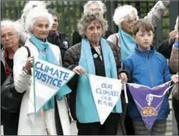  ?? ?? Protesters hold pennants during a rally before the European Court of Human Rights issued three verdicts related to climate change, in Strasbourg, France, on Tuesday.