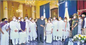  ?? ANI ?? West Bengal governor Jagdeep Dhankhar, along with chief minister Mamata Banerjee and the newly sworn-in ministers, during a ceremony at Raj Bhavan in Kolkata on Monday.