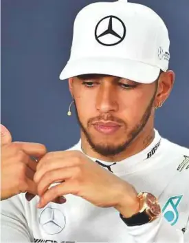  ?? AFP ?? Mercedes driver Lewis Hamilton fails to raise a smile during a press conference after the Australian Grand Prix in Melbourne on Sunday.