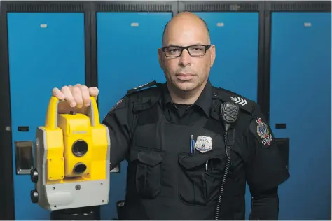  ?? MICHAEL BELL ?? Sgt. Andrew Puglia of the Regina Police Service stands with survey equipment at headquarte­rs. The equipment is used to analyze traffic accidents, of which Puglia has investigat­ed many in his career.