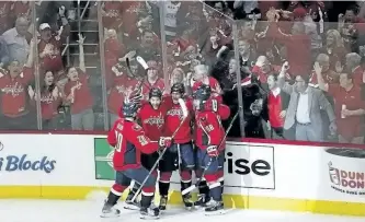  ?? CAROLYN KASTER/THE ASSOCIATED PRESS ?? Washington Capitals’ Alex Ovechkin (8), celebrates scoring a goal against the Pittsburgh Penguins with teammates, Lars Eller (20) Tom Wilson (43), Kevin Shattenkir­k (22), and Nate Schmidt (88), during the third period of Game 5 on Saturday. The...