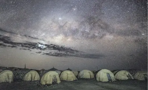  ??  ?? TRAVELLERS take shelter in dome tents at a campsite near Lake Abbé, Djibouti. The area is a day’s drive away from the new rail line that runs from Addis Ababa, Ethiopia, to Djibouti City on the coast of the Red Sea. | The New York Times