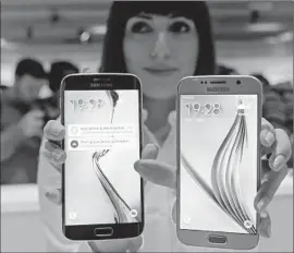  ?? Manu Fernandez
Associated Press ?? SAMSUNG’S NEW GALAXY S6, right, and S6 Edge. The Edge costs about $100 more and offers curved screens to glance at content from the side.