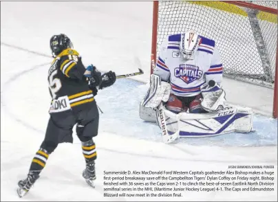  ?? JASON SIMMONDS/JOURNAL PIONEER ?? Summerside D. Alex MacDonald Ford Western Capitals goaltender Alex Bishop makes a huge first-period breakaway save off the Campbellto­n Tigers’ Dylan Coffey on Friday night. Bishop finished with 36 saves as the Caps won 2-1 to clinch the best-of-seven...