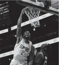  ?? JOHN BAZEMORE/AP ?? Clippers forward Kawhi Leonard goes up for a basket as Hawks forward Onyeka Okongwu defends during the first half of the Clippers’ win on Monday in Atlanta.