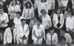  ?? OLIVIER DOULIERY/ABACA PRESS ?? House Democratic women, including Rep. Alexandria Ocasio-Cortez (D-N.Y.), middle, are dressed in white for President Trump’s State of the Union address to a joint session of Congress on Capitol Hill in Washington, D.C., on Tuesday.