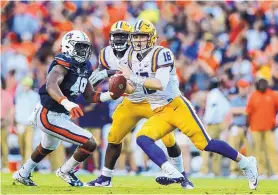  ?? BUTCH DILL/ASSOCIATED PRESS ?? LSU quarterbac­k Danny Etling (16) scrambles away from pressure during the Tigers’ loss to Auburn on Saturday. LSU fired head coach Les Miles Sunday.