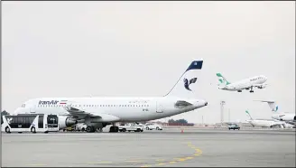  ??  ?? In this file photo, an Iranian Mahan Air passenger plane takes off as a plane of Iran’s national air carrier Iran Air (left), is parked at Mehrabad airport in Tehran, Iran. European airplane manufactur­er ATR said it signed a deal with
Iran Air for 20...