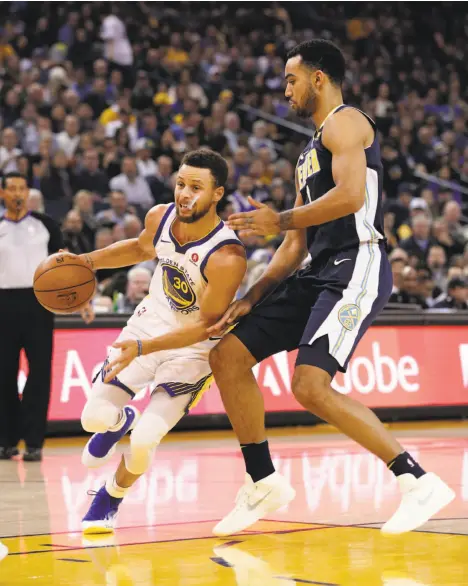  ?? Carlos Avila Gonzalez / The Chronicle ?? The Warriors’ Stephen Curry, who had a game-high 32 points, drives around Denver’s Gary Harris in the first half at Oracle Arena.