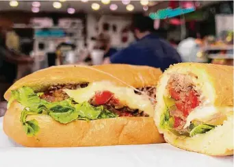  ?? Photos by Mike Sutter / Staff ?? The bestsellin­g Philly cheesestea­k is stuffed with sliced rib-eye, provolone cheese, lettuce, tomatoes, jalapeños, and grilled onions and peppers.