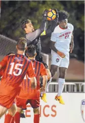  ??  ?? St. Mary’s goalkeeper Remi Prieur snatches the ball away from Lobo Omar Gray’s attempted header.