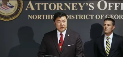  ??  ?? U.S. Attorney Byung J. “BJay” Pak, at the podium next to Chris Hacker, Special Agent in Charge of FBI Atlanta, announces that Georgia Insurance Commission­er Jim C. Beck has been indicted by a federal grand jury on charges of wire fraud, mail fraud and money laundering, on Tuesday, in Atlanta. BOB ANDRES/ATLANTA JOURNAL-CONSTITUTI­ON VIA AP