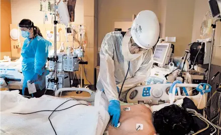  ?? JAE C. HONG/AP ?? Dr. Rafik Abdou checks on a COVID-19 patient last month at Providence Holy Cross Medical Center in Los Angeles.