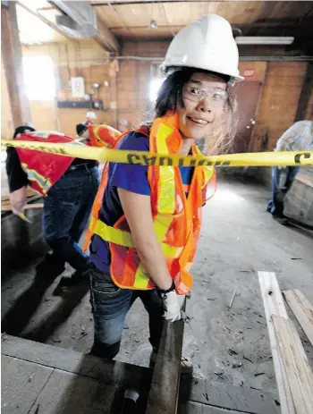  ?? JOHN LUCAS/EDMONTON JOURNAL ?? Volunteer youth Aimee Bellerose helps renovate inside iHuman’s new space at 9635 102A Ave. on Saturday. The two-storey space is a roomy 22,000 square feet.