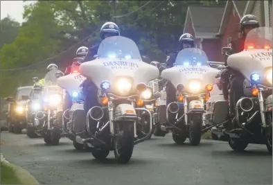  ?? Rob Ryser / Hearst Connecticu­t Media ?? George Johnson, a retired Danbury Police Department captain, was buried with full honors on Monday, including police escort from the New Hope Baptist Church to Wooster Cemetery in Danbury.