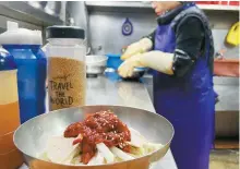  ?? Korea Times photo by Lee Hae-rin ?? A restaurant employee prepares a bowl of milmyeon at Naeho Naengmyeon, a restaurant in Uam-dong, Busan, Dec. 19, 2023. The restaurant is the birthplace of milmyeon, a Busan specialty originatin­g from North Korea.