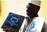  ??  ?? This file photo shows Niger’s self-taught legendary musician Mamman Sani posing with his first and second albums. — AFP photos