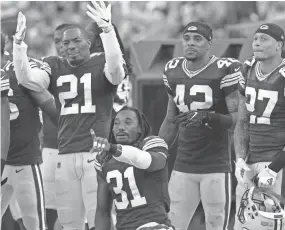  ?? MARK HOFFMAN/MILWAUKEE JOURNAL SENTINEL ?? Packers defensive backs (from left) Ha Ha Clinton-Dix, Davon House, Morgan Burnett and Josh Jones encourage a photograph­er to take their picture during the season opener at Lambeau Field. Getting both Burnett and Jones on the field at the same time...