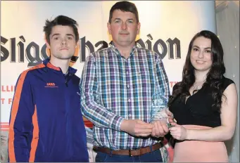  ??  ?? Padraig Henry of Eastern Harps GAA receives the Community Participat­ion Initiative Award from Jessica Farry of the Sligo Champion and Justin Curran, representi­ng Jako Sports.