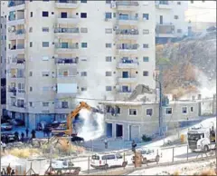  ?? AHMAD GHARABLI/AFP ?? Israeli security forces tear down one of the Palestinia­n buildings still under constructi­on which have been issued notices to be demolished in the West Bank village of Dar Salah.