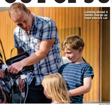  ?? Picture: GETTY ?? Looking ahead: A family charge up their electric car