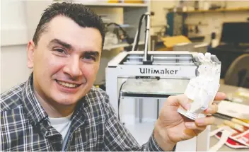  ?? BRUCE STOTESBURY/TIMES COLONIST FILES ?? Nick Dechev, executive director of the Victoria Hand Project, says the 3D printing and scanning technology is able to design a perfect fit for amputees.