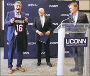  ?? Pat Eaton-Robb / Associated Press ?? Thomas C. Katsouleas, left, is presented with a University of Connecticu­t basketball jersey by UConn Board of Trustees Chairman Thomas Kruger, center, and Gov. Ned Lamont after being appointed the university’s 16th president on Tuesday in Storrs.