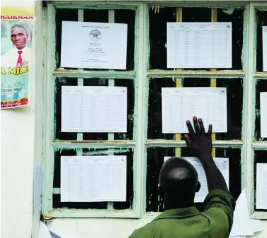  ?? REUTERS ?? Un keniano mira la lista electoral en Eldoret, Kenia, ayer