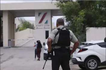  ?? KARIM TORRES / AP file ?? Government forces guard the entrance of hotel after an armed confrontat­ion near Puerto Morelos, Mexico, thursday. two suspected drug dealers were killed after gunmen from competing gangs staged a dramatic shootout near upscale hotels that sent foreign tourists scrambling for cover.