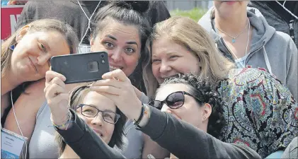  ?? KENN OLIVER/THE TELEGRAM ?? Young Adult Cancer Cancer annual Survivor Conference attendees take selfies following the launch of the YAC Prime Study, which aims to be the largest of its kind to date and explore the physical, social, and emotional challenges faced by young adults...