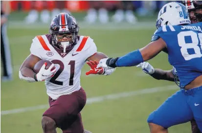  ?? NELL REDMOND/ASSOCIATED PRESS ?? Virginia Tech running back Khalil Herbert carries the ball against Duke in the second half on Saturday. Herbert has establishe­d himself in the early stages of the season as not only the most surprising back in the ACC, but also the most productive one in the nation.