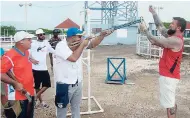  ?? FILE ?? Ben Husthwaite (right), 19-time world shooting champion, instructs national shotgun champion Christian Sasso (second right) on how to anticipate the position of the clay and where to shoot at the Jamaica Skeet Club in Portmore. Looking on are Leighton...